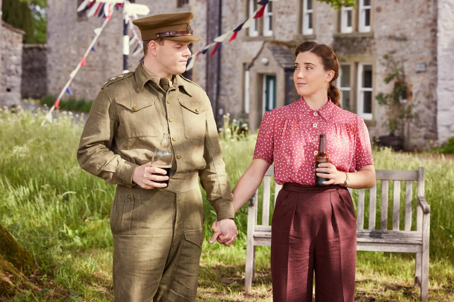 Tristan Farnon and Charlotte Beauvoir at a village celebration with bunting overhead