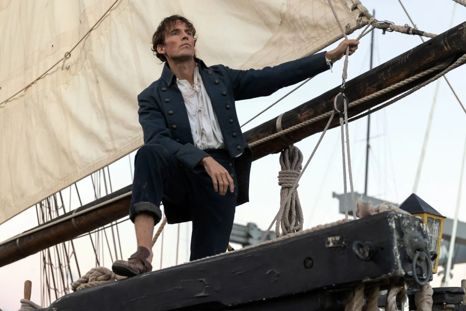 Edmond Dantès standing at the bow of a sailing ship, looking to the horizon